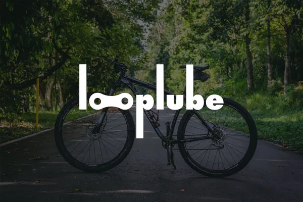 Looplube India logo with a cycle in the background